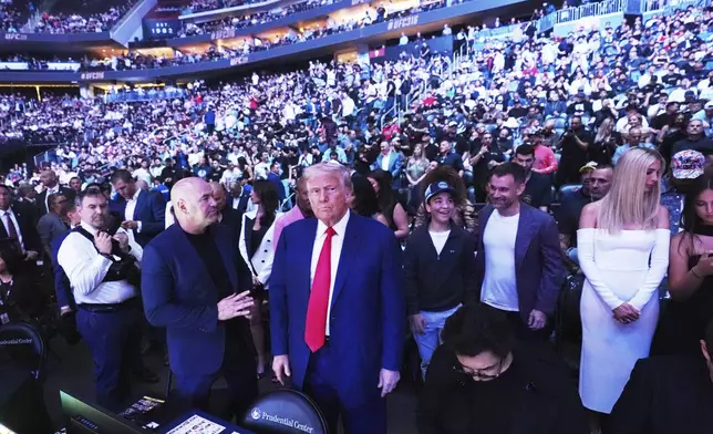 President Donald Trump attends the UFC-316 mixed martial arts event, at the Prudential Center, Saturday, June 7, 2025, in Newark, N.J., as UFC's Dana White, looks on. (AP Photo/Frank Franklin II)