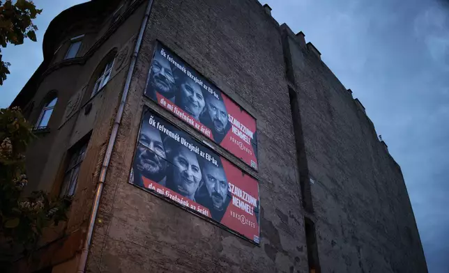 A Hungarian government billboard, opposing Ukraine's EU membership, showing, from left, the leader of the European People's Party Manfred Weber, European Commission President Ursula von der Leyen and Ukrainian President Volodymyr Zelenskyy which reads "They would bring Ukraine into the EU, but we would pay the price! Let's vote no!", is placed on a building In Budapest, Hungary, Monday, June 16, 2025. (AP Photo/Bela Szandelszky)