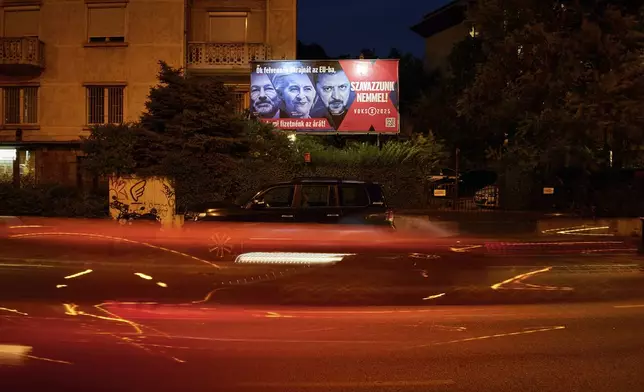 A Hungarian government billboard, opposing Ukraine's EU membership, showing, from left, the leader of the European People's Party Manfred Weber, European Commission President Ursula von der Leyen and Ukrainian President Volodymyr Zelenskyy which reads "They would bring Ukraine into the EU, but we would pay the price! Let's vote no!", is placed on a street In Budapest, Hungary, Monday, June 16, 2025. (AP Photo/Bela Szandelszky)