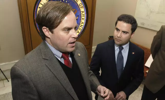FILE - Sen. Jon Woods, R-Springdale, left, speaks to reporters at the Arkansas state Capitol in Little Rock, Ark., Wednesday, Feb. 13, 2013. (AP Photo/Danny Johnston, File)