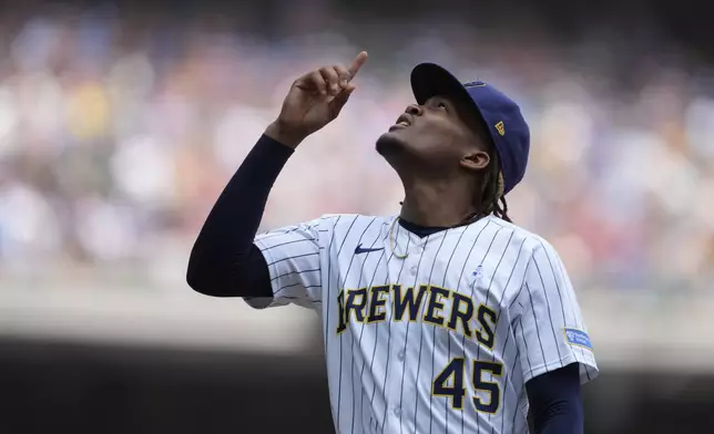 Milwaukee Brewers' Abner Uribe gestures as he walks to the dugout during the seventh inning of a baseball game against the St. Louis Cardinals, Sunday, June 15, 2025, in Milwaukee. (AP Photo/Aaron Gash)