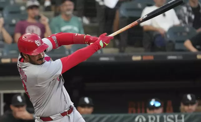 St. Louis Cardinals' Nolan Arenado hits a one-run single during the 10th inning in the second baseball game of a doubleheader against the Chicago White Sox, Thursday, June 19, 2025. (AP Photo/Nam Y. Huh)