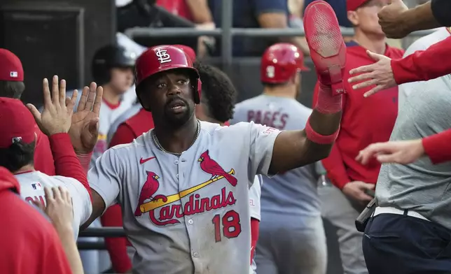 St. Louis Cardinals' Jordan Walker (18) celebrates with teammates after scoring on a one-run single by Nolan Arenado during the 10th inning in the second baseball game of a doubleheader against the Chicago White Sox Thursday, June 19, 2025. (AP Photo/Nam Y. Huh)