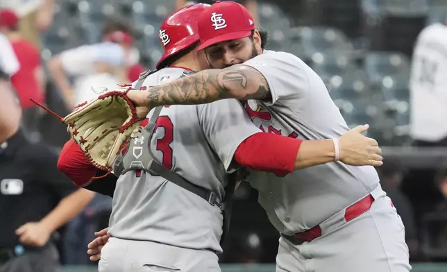 St. Louis Cardinals catcher Pedro Pagés, left, celebrates with relief pitcher Andre Granillo after they defeated the Chicago White Sox in the second baseball game of a doubleheader Thursday, June 19, 2025. (AP Photo/Nam Y. Huh)