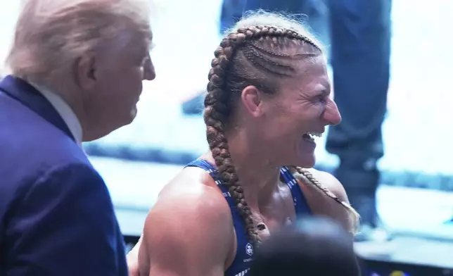 President Donald Trump congratulates Kayla Harrison after winning her women's bantamweight bout against Julianna Pena during the UFC-316 mixed martial arts event, at the Prudential Center, Saturday, June 7, 2025, in Newark, N.J. (AP Photo/Manuel Ceneta)