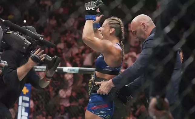Kayla Harrison celebrates after winning her women's bantamweight bout against Julianna Peña at the UFC 316 mixed martial arts event Sunday, June 8, 2025 in Newark, N.J. (AP Photo/Frank Franklin II)