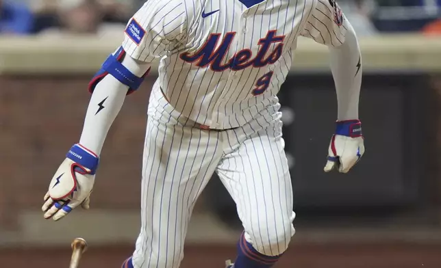 New York Mets' Brandon Nimmo follows through on a home run during the seventh inning of a baseball game against the Washington Nationals Wednesday, June 11, 2025, in New York. (AP Photo/Frank Franklin II)