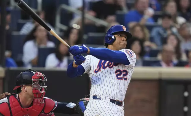 New York Mets' Juan Soto (22) follows through on a two-run home run during the third inning of a baseball game against the Washington Nationals Wednesday, June 11, 2025, in New York. (AP Photo/Frank Franklin II)