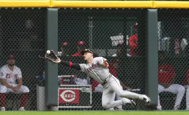 Arizona Diamondbacks outfielder Alek Thomas makes a diving catch on a fly ball hit by Cincinnati Reds' Gavin Lux during the first inning of a baseball game, Sunday, June 8, 2025, in Cincinnati. (AP Photo/Jeff Dean)