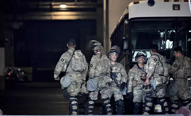 Members of the U.S. military take a break at the downtown Metropolitan Detention Center Tuesday, June 17, 2025, in Los Angeles. (AP Photo/Wally Skalij)