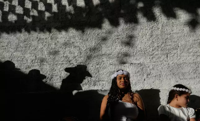 Revelers participate in the Cavalhadas, or Holy Spirit, Festival, in Pirenopolis, Goias state, Brazil, Sunday, June 8, 2025. (AP Photo/Eraldo Peres)