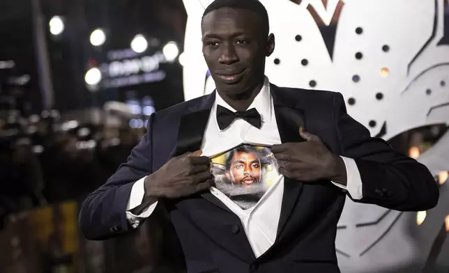 FILE - Khaby Lame opens his shirt to reveal the image of Chadwick Boseman upon arrival for the premiere of the film 'Black Panther: Wakanda Forever' in London, Nov. 3, 2022. (Photo by Vianney Le Caer/Invision/AP File)