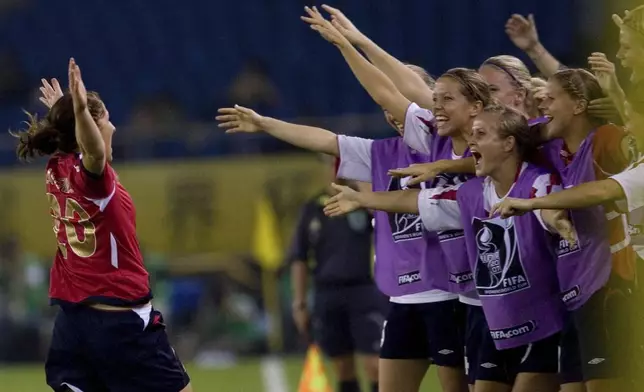 FILE - Norway's Lise Klaveness, left celebrates after scoring against Ghana during a Group C match for the FIFA Women's World Cup soccer tournament held in Hangzhou, eastern China's Zhejiang province, Thursday, Sept 20, 2007. (AP Photo/Ng Han Guan, File)
