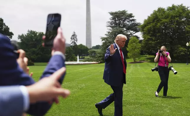 President Donald Trump arrives on the South Lawn of the White House, Monday, June 9, 2025, in Washington. The Washington Monument is seen in background. (AP Photo/Evan Vucci)