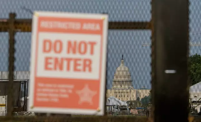 The U.S. Capitol is seen through security fencing, set up on the National Mall, during preparations for an upcoming military parade commemorating the Army's 250th anniversary and coinciding with President Donald Trump's 79th birthday, Thursday, June 12, 2025, in Washington. (AP Photo/Rod Lamkey, Jr.)