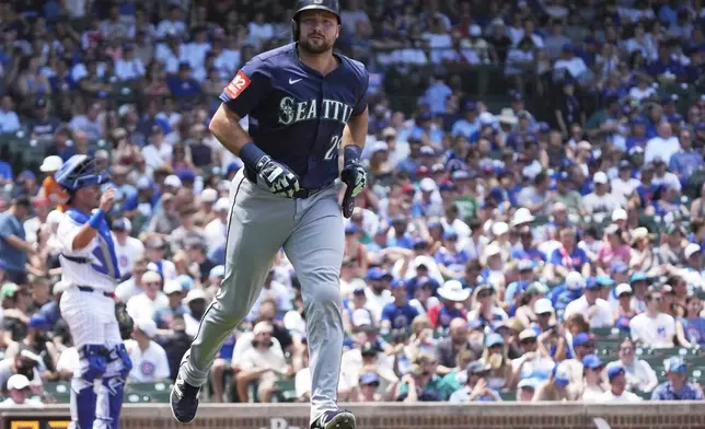 Seattle Mariners' Cal Raleigh walks to first base during the third inning of a baseball game against the Chicago Cubs in Chicago, Sunday, June 22, 2025. (AP Photo/Nam Y. Huh)