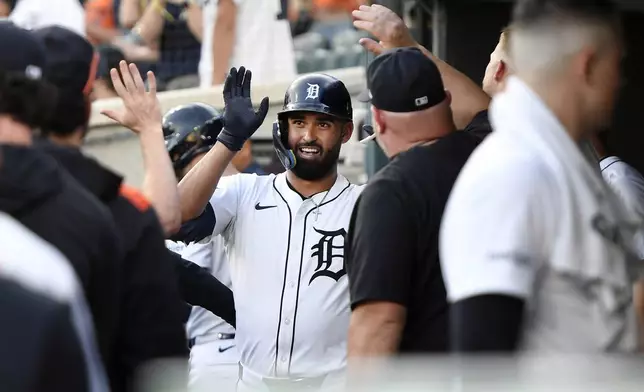 Detroit Tigers' Riley Greene, center, is congratulated in the dugout after hitting a home run during the fourth inning of a baseball game against the Minnesota Twins, Sunday, June 29, 2025, in Detroit. (AP Photo/Jose Juarez)