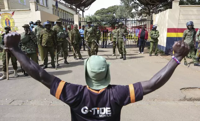 Kenyan police stand guard as a demonstrator reacts to the death of Kenyan blogger Albert Ojwang, who died while in police custody, in Nairobi, Monday, June 9, 2025. (AP Photo/Andrew Kasuku)