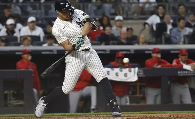 New York Yankees' Giancarlo Stanton hits a single during the fourth inning of a baseball game against the Los Angeles Angels, Monday, June 16, 2025, in New York. (AP Photo/Pamela Smith)