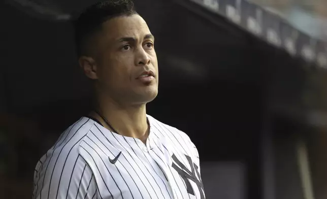 New York Yankees' Giancarlo Stanton stands in the dugout during the second inning of a baseball game against the Los Angeles Angels, Monday, June 16, 2025, in New York. (AP Photo/Pamela Smith)