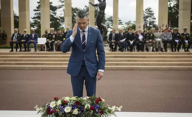 U.S. Defense Secretary Pete Hegseth lays a wreath of flowers during a ceremony at the US cemetery to commemorate the 81st anniversary of the D-Day landings, Friday, June 6, 2025 in Colleville-sur-Mer, Normandy. (AP Photo/Thomas Padilla)