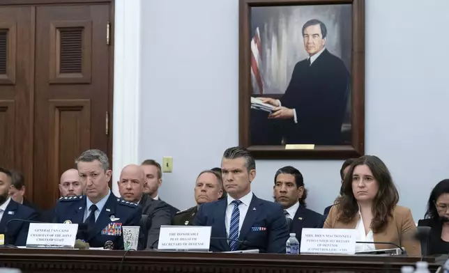 The Chairman of the Joint Chiefs of Staff General Dan Caine, left, Department of Defense Secretary Pete Hegseth and Bryn MacDonnell, Special Assistant to the Secretary of Defense, Performing the Duties of the Under Secretary of Defense and Chief Financial Officer, testify before the House Committee on Appropriations subcommittee oversight hearing on the Department of Defense, on Capitol Hill in Washington, Tuesday, June 10, 2025. (AP Photo/Jose Luis Magana)