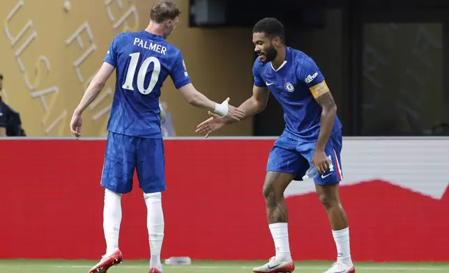 Chelsea's Reece James, right, celebrates with Cole Palmer after scoring the opening goal against Benfica during the Club World Cup round of 16 soccer match between Benfica and Chelsea in Charlotte, N.C., Saturday, June 28, 2025. (AP Photo/Nell Redmond)