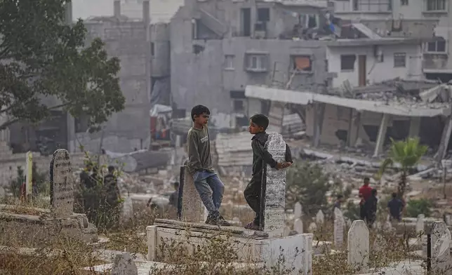 Palestinians visit their relatives graves at Sheikh Radwan cemetery in Gaza City on the first day of Eid al-Adha, Friday, June 6, 2025. (AP Photo/Jehad Alshrafi)