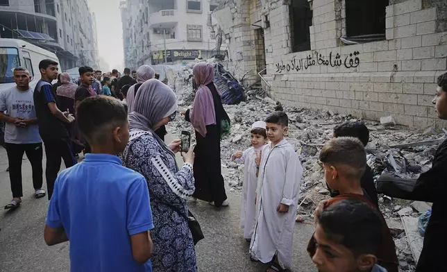 Palestinians gather for Eid al-Adha prayers beside the ruins of Al-Kanz mosque destroyed by Israeli bombardment, in Gaza City on Friday, June 6, 2025. (AP Photo/Jehad Alshrafi)