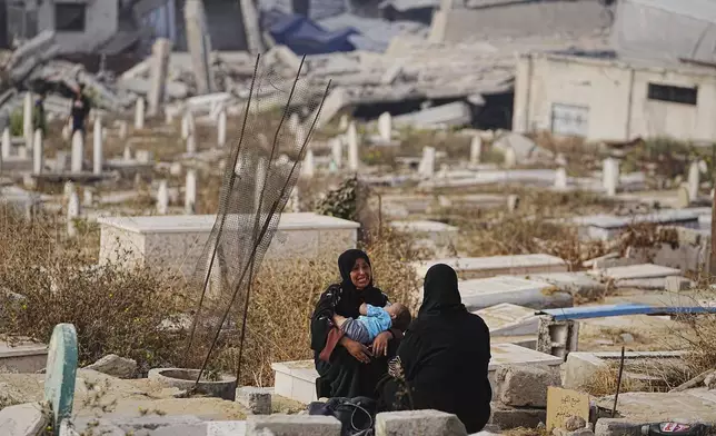 Palestinians visit their relatives graves at Sheikh Radwan cemetery in Gaza City on the first day of Eid al-Adha, Friday, June 6, 2025. (AP Photo/Jehad Alshrafi)