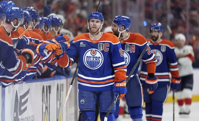 Edmonton Oilers centre Connor McDavid, front right, celebrates after his goal with teammates during the third period in Game 5 of the NHL hockey Stanley Cup Final against the Florida Panthers in Edmonton, Alberta, Saturday, June 14, 2025. (Darryl Dyck/The Canadian Press via AP)