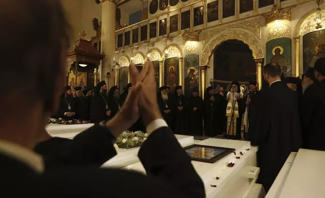 Clergy and mourners attend a funeral service for victims of Sunday's suicide bombing at Mar Elias Greek Orthodox Church, held at al-Saleeb Church in the al-Qasaa neighborhood of Damascus, Syria, Tuesday, June 24, 2025. (AP Photo/Omar Sanadiki)