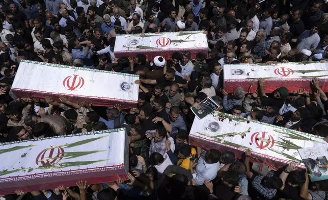 Mourners carry the flag-draped coffins of five men, whose names were not immediately available, reportedly killed in Israeli strikes, during their funeral in the city of Khorramabad, Iran, Monday, June 16, 2025. (AP Photo/Aziz Babanezhad/Tasnim News Agency)