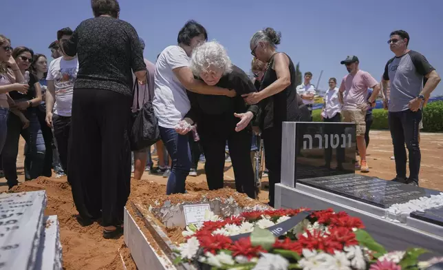 Relatives and friends of Daisy Yitzhaki, 85, who was killed during an Iranian missile attack, mourn during her funeral at Segula cemetery in Petah Tikva, Israel, Wednesday, June 18, 2025. (AP Photo/Oded Balilty)