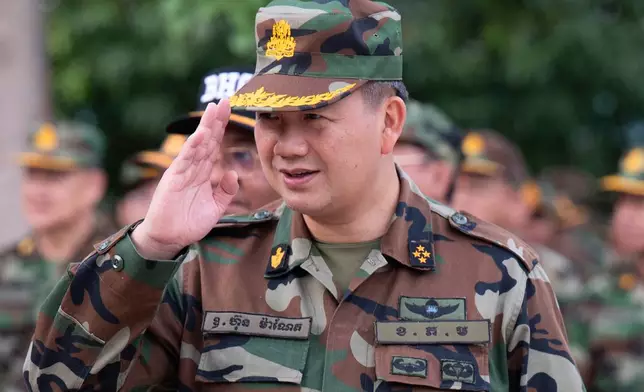 In this photo released by Agence Kampuchea Press (AKP), Cambodian Prime Minister Hun Manet reviews his troop during his visit to Preah Vihear, near Cambodia-Thailand border in Preah Vihear province, Cambodia, Monday, June 23, 2025. (AKP via AP)