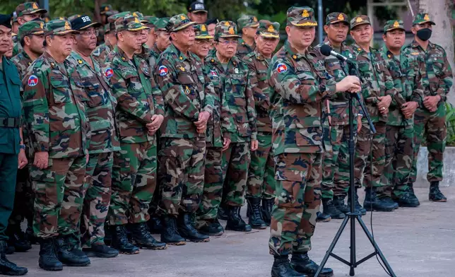 In this photo released by Agence Kampuchea Press (AKP), Cambodian Prime Minister Hun Manet, foreground, delivers a speech in front of his troop during his visit to Preah Vihear, near Cambodia-Thailand border in Preah Vihear province, Cambodia, Monday, June 23, 2025. (AKP via AP)
