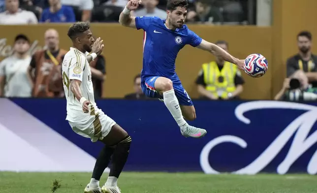 Chelsea's Pedro Neto, right, and Los Angeles FC's Denis Bouanga fight for the ball during the Club World Cup group D soccer match between Chelsea and Los Angeles FC in Atlanta, Monday, June 16, 2025. (AP Photo/Brynn Anderson)