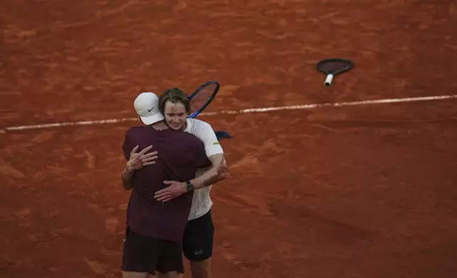 Winner Kazakhstan's Alexander Bublik, right, hugs with Britain's Jack Draper after their fourth round match of the French Tennis Open at the Roland-Garros stadium in Paris, Monday, June 2, 2025. (AP Photo/Christophe Ena)