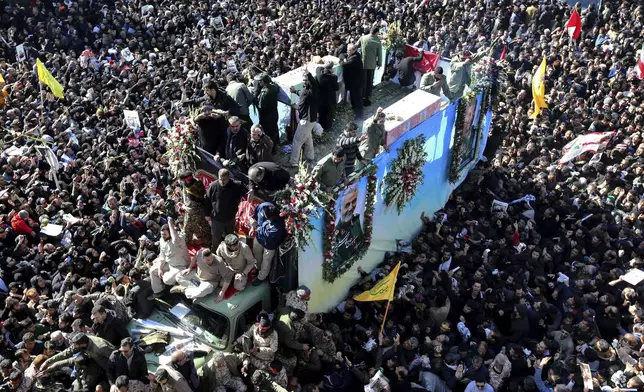 FILE - Coffins of Gen. Qassem Soleimani and others who were killed in Iraq by a U.S. drone strike, are carried on a truck surrounded by mourners during a funeral procession, in the city of Kerman, Iran, Jan. 7, 2020. (AP Photo, File)