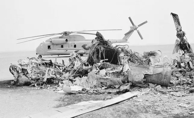 FILE - Remains of a burned-out U.S. helicopter lis photographed in the eastern desert region of Iran, April 27,1980, one day after an abortive American commando raid to free the U.S. Embassy hostages. (AP Photo, File)