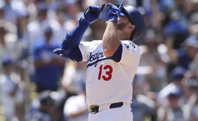 Los Angeles Dodgers' Max Muncy gestures after hitting a grand slam during the sixth inning of a baseball game against the Washington Nationals in Los Angeles, Sunday, June 22, 2025. (AP Photo/Jessie Alcheh)