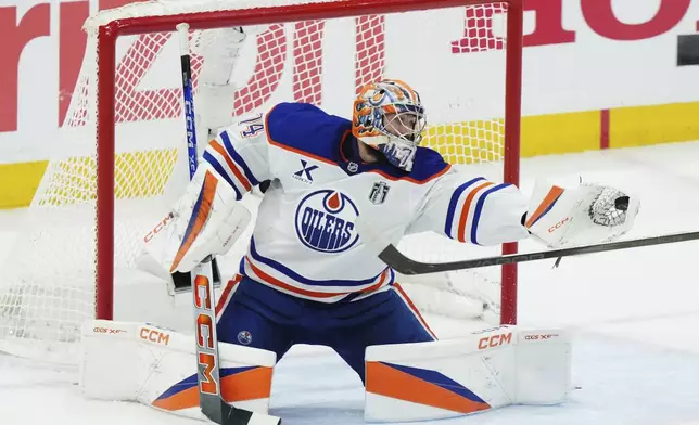 Edmonton Oilers goalie Stuart Skinner makes a save against the Florida Panthers during the first period in Game 4 of the NHL hockey Stanley Cup Final in Sunrise, Fla., Thursday, June 12, 2025. (Nathan Denette/The Canadian Press via AP)