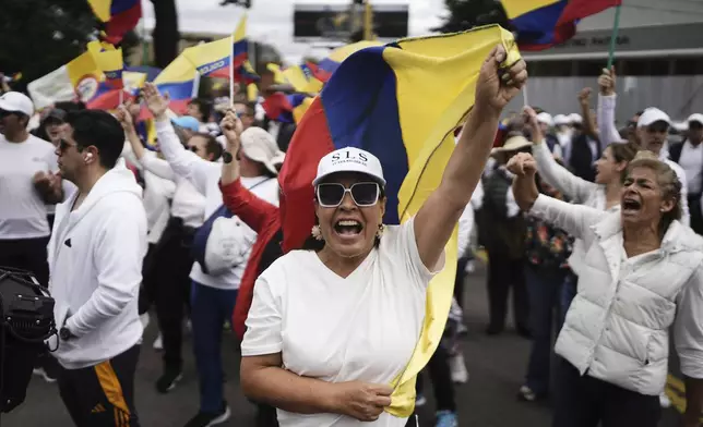 People march to the clinic where Colombian Senator Miguel Uribe Turbay is being treated after he was shot, in Bogota, Colombia, Sunday, June 8, 2025. (AP Photo/Ivan Valencia)