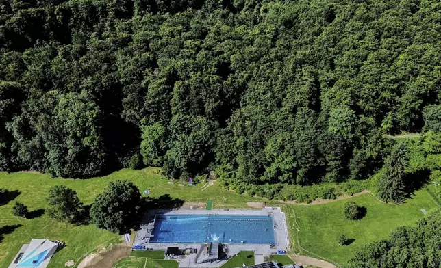 A public pools is located at the edge of a forest of the Taurus region in Neu-Anspach near Frankfurt, Germany, Friday, June 20, 2025. (AP Photo/Michael Probst)