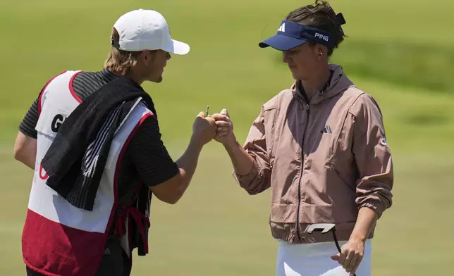 Linn Grant, of Sweden, celebrates with her caddie after a long putt on the fifth hole during the third round of the U.S. Women's Open golf tournament at Erin Hills Saturday, May 31, 2025, in Erin, Wis. (AP Photo/Jeff Roberson)