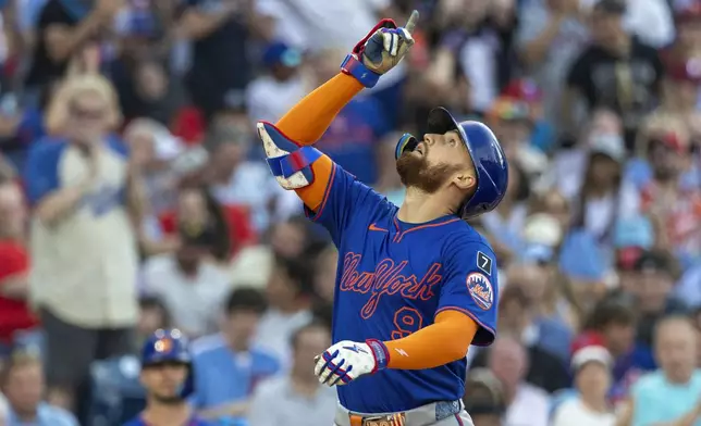 New York Mets' Brandon Nimmo celebrates after his solo home run during the first inning of a baseball game against the Philadelphia Phillies, Saturday, June 21, 2025, in Philadelphia. (AP Photo/Laurence Kesterson)