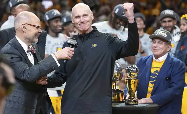 Indiana Pacers head coach Rick Carlisle, center, celebrates after his team won Game 6 of the Eastern Conference finals of the NBA basketball playoffs against the New York Knicks in Indianapolis, Saturday, May 31, 2025. (AP Photo/Michael Conroy)