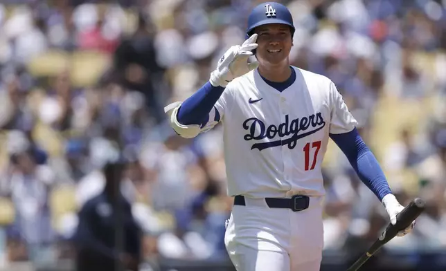 Los Angeles Dodgers' Shohei Ohtani gestures before his first at-bat during the first inning of a baseball game against the Washington Nationals in Los Angeles, Sunday, June 22, 2025. (AP Photo/Jessie Alcheh)