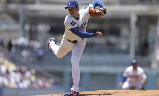 Los Angeles Dodgers starting pitcher Shohei Ohtani follows through on a throw to a Washington Nationals batter during the first inning of a baseball game in Los Angeles, Sunday, June 22, 2025. (AP Photo/Jessie Alcheh)