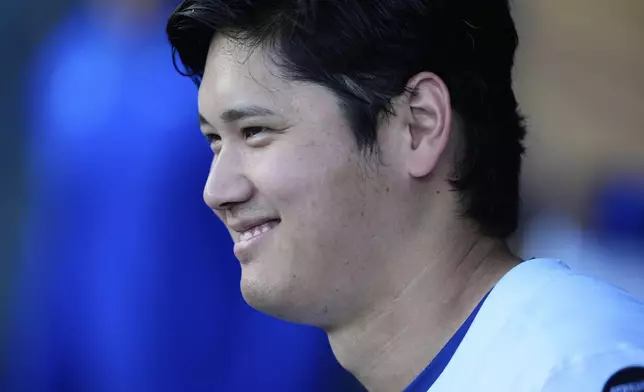 Los Angeles Dodgers' Shohei Ohtani smiles in the dugout before a baseball game against the San Diego Padres, Thursday, June 19, 2025, in Los Angeles. (AP Photo/Mark J. Terrill)